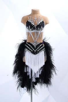 a mannequin dressed in black and white feathers