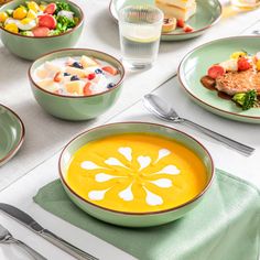 a table topped with plates and bowls filled with food