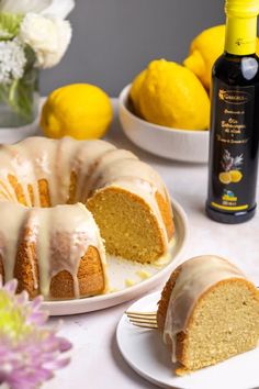 a bundt cake with icing and lemons in the background