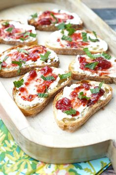 several pieces of bread topped with cheese and toppings