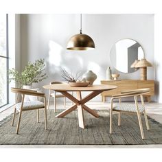 a dining room table and chairs in front of a wall with a mirror on it