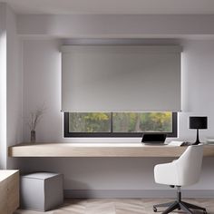 a desk with a laptop computer on top of it next to a window covered in blinds