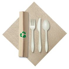 a napkin, fork, spoon and knife on top of a wooden box with a green sticker