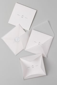 three white envelopes sitting on top of each other