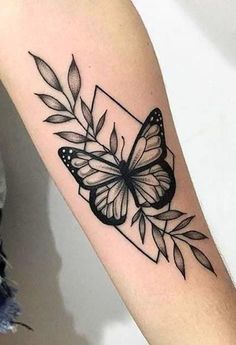 a black and white butterfly tattoo on the arm