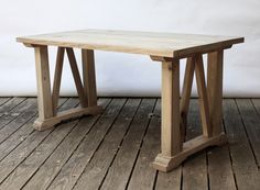 a wooden table sitting on top of a wooden floor