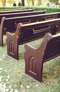 two rows of benches sitting in the grass