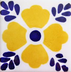 a yellow and blue flower design on a white tile wall with dark circles in the center