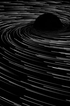 an abstract black and white photo with lines in the shape of a circle that looks like a star