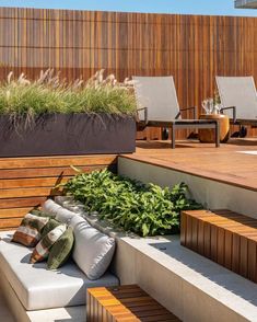 an outdoor seating area with wooden benches and plants