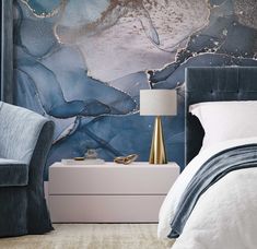 a modern bedroom with blue and gold wallpaper