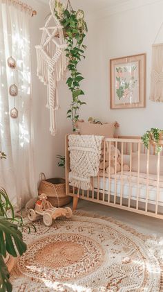 a baby's room with a crib, rugs and potted plants