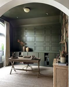 an archway leading into a living room filled with furniture and bookshelves on the wall