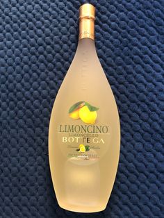 a bottle of limoo bottega on a blue cloth