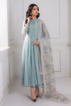 Introducing our stunning Light Blue Chiffon Silk Suit Anarkali Dress, complete with an embroidered net dupatta and a grip silk trouser. Create a head-turning look with this elegant 3-piece set, including the top, trouser, and dupatta, along with accompanying accessories. Elevate your style with the luxurious embroidered chiffon fabric. Top Fabric: Chiffon Dupatta Fabric: Embroidered Net Trouser Fabric: Grip silk Top Length: 50"-52" Sleeves Length: 21"-23" Bottom Length: 36"-37" Condition: New Oc Pastel Blue Anarkali, Pakistani Dupatta Designs, Pakistani Frock Design, Blue Pakistani Dress, Traditional Dresses For Women, Dyed Pants, Pakistani Party Wear, Party Frocks, Pakistani Fancy Dresses