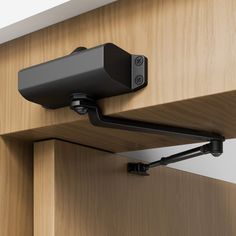 a camera mounted to the side of a wooden cabinet