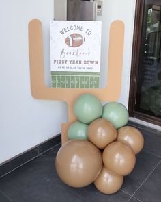 balloons are stacked on top of an inflatable chair for a football themed party