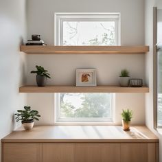 two wooden shelves with plants on them in front of a window and some windowsills