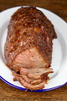 a large piece of meat on a white plate