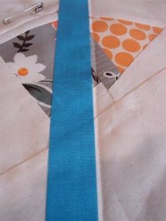 a close up of a piece of cloth with a blue ribbon on it