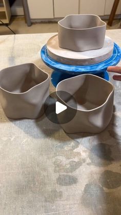 three bowls and two plates on a table