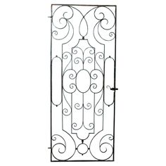 an iron door with scroll designs on the front and side panels, isolated against a white background