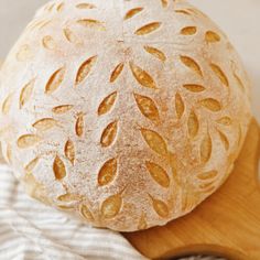 a loaf of bread sitting on top of a wooden cutting board