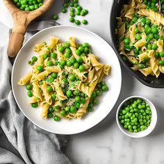 pasta with peas and parmesan cheese in a skillet next to two bowls