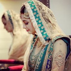 a woman in a wedding dress looking down at her phone