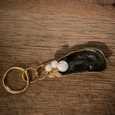 a pair of gold toned scissors sitting on top of a wooden table