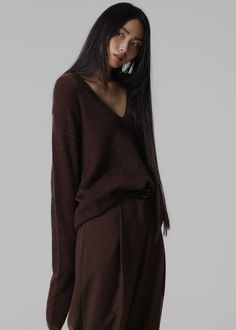 Color: Brown Lightweight wool blend fabric Regular fit Deep v neck Drop shoulders Rib knit trim Slip on style Unlined 35% Polyamide 30% Wool 25% Alpaca 10% Acrylic Dry Clean Imported