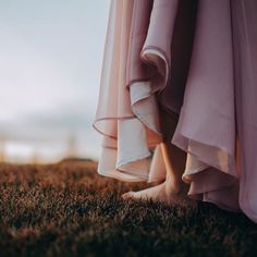 a woman's legs in the grass with her dress pulled up to show off