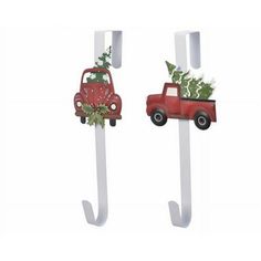 two red trucks with christmas decorations on them are hanging from the hooks in front of each other