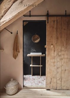 an open door leading to a bathroom with a sink and towel on the rack next to it