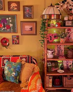 a living room filled with lots of furniture and pictures on the wall next to it