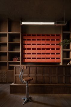 a chair sitting in front of a wooden book shelf filled with lots of shelves and drawers