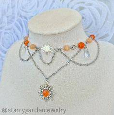 * Orange Sun Choker Necklace - "Golden Horizon" *  Made with a striking sun charm and vibrant orange glass beads, delicate chains and clear teardrop beads.  ❀ Materials: Stainless steel, glass beads and zinc alloy charms. ❀ Length: 33-38 cm. ➤ 𝘑𝘦𝘸𝘦𝘭𝘳𝘺 𝘊𝘢𝘳𝘦 ❀ Please handle this delicate product with care. ❀ Please avoid exposing it to water, perfumes, lotions, and harsh chemicals. ❀ Store your jewelry in a dry, clean place to prevent tarnishing and scratches. ➤ 𝘚𝘩𝘪𝘱𝘱𝘪𝘯𝘨 𝘐𝘯𝘧? Sun Choker, Cottagecore Necklace, Fairycore Necklace, Sun Charm, Teardrop Beads, Necklace Beaded, Vibrant Orange, Jewelry Care, Necklace Etsy