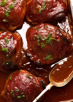 meatballs covered in sauce and garnished with parsley