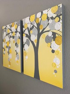 two yellow and gray paintings hanging on the wall