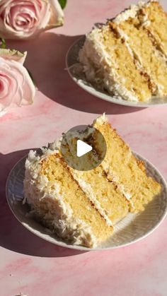 two slices of cake sitting on top of white plates with pink flowers in the background