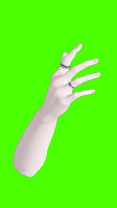 a white hand with black dots on it's fingers is shown in front of a green background