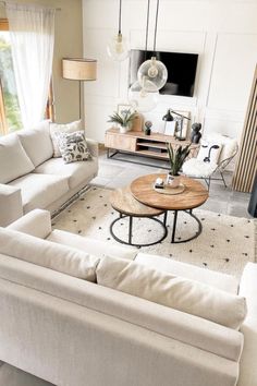 a living room filled with furniture and a flat screen tv mounted to the side of a wall