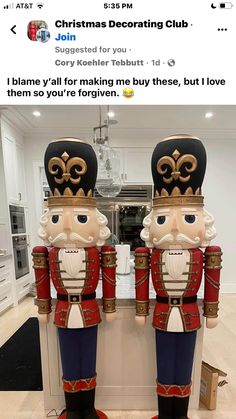 two wooden nutcrackers standing next to each other in front of a kitchen