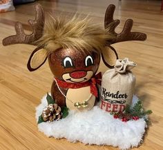 a reindeer doll next to a bag on the floor