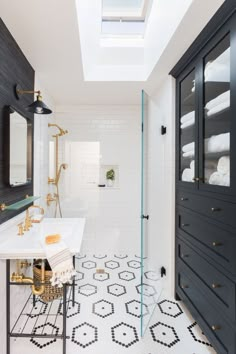 a black and white bathroom with skylight