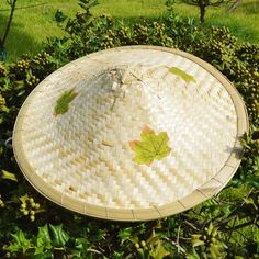 The hat is woven from natural bamboo, and 3 pieces of artificial maple leaves are pasted for surface decoration This natural bamboo braided costume hat includes a chin cord to keep the hat in place Wear this as you work in your garden on sunny days keeping with the traditional use This natural bamboo hand made Item makes a fantastic decoration for a theme party or as a wall decoration That hat is fantastic as a costume accessory Traditional Brimmed Straw Hat In Natural Color, Ninja Hat, Chinese Hat, Bamboo Hat, Bamboo Hats, Leaf Decoration, Surface Decoration, Maple Leaves, Leaf Decor