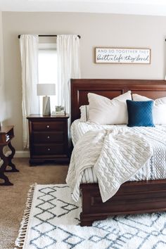 a bedroom with a bed, dresser and window