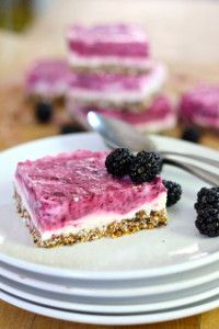 there is a piece of cake on the plate with blackberries and raspberries