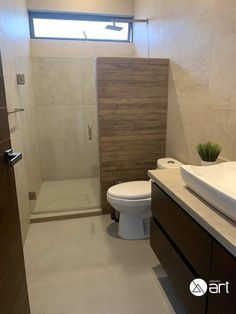 a bathroom with a toilet, sink and shower stall