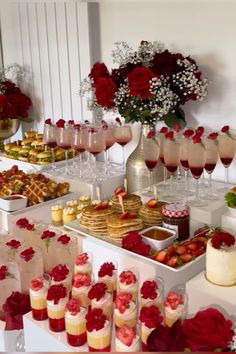 a table filled with lots of desserts and wine glasses on top of each other